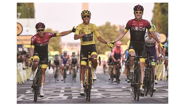 Team Ineos riders Jonathan Castroviejo (left) of Spain and Geraint Thomas (right) of Britain congratulate Egan Bernal of Colombia as he celebrates his victory on the finish line of the 21st and last stage of the Tour de France at Champs-Elysees, in Paris, yesterday. (AFP)