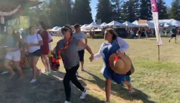 People run as an active shooter was reported at the Gilroy Garlic Festival, south of San Jose, California, yesterday, in this still image taken from a social media video