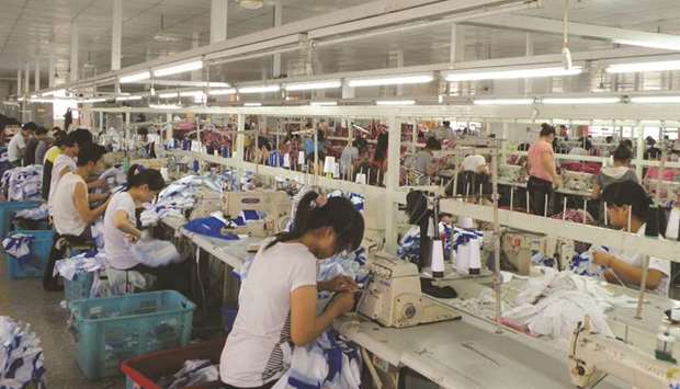 Workers make Orolay jackets at the companyu2019s factory complex in Jiaxing, Zhejiang province.