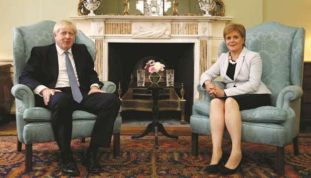 Prime Minister Boris Johnson poses for a photograph with Scotlandu2019s First Minister Nicola Sturgeon at Bute House in Edinburgh yesterday.