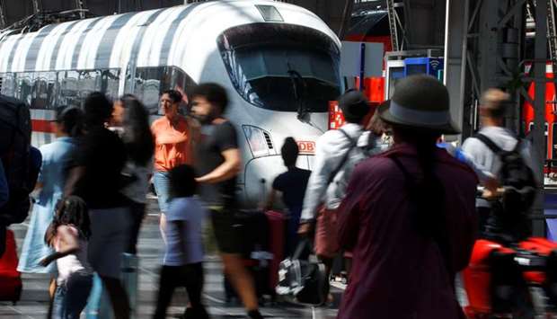 Passengers are pictured at the main train station in Frankfurt, Germany
