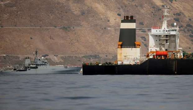 A British Royal Navy patrol vessel guards the Iranian oil tanker Grace 1 as it sits anchored anchored after it was seized earlier this month by British Royal Marines off the coast of the British Mediterranean territory on suspicion of violating sanctions against Syria, in the Strait of Gibraltar, southern Spain on July 20.