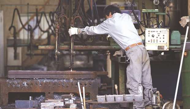 A man works around a metal procession machine at a factory in Urayasu, east of Tokyo. Japanu2019s industrial output sank 3.6% in June, government data showed yesterday.