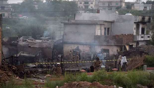 Pakistani soldiers cordon off the site where a Pakistani Army Aviation Corps aircraft crashed in Rawalpindi