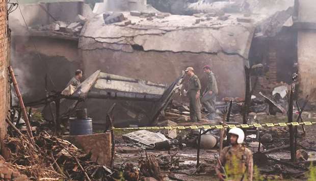 Soldiers secure the site in Rawalpindi where the Aviation Corps aircraft crashed.