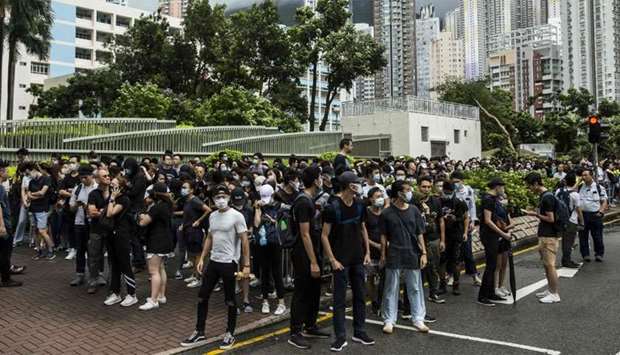 Demonstrators gather outside the Eastern district court in Hong Kong in support of protesters who have been charged with rioting during recent clashes with police