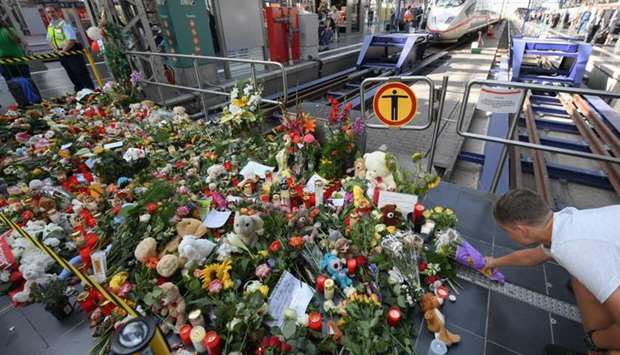 A makeshift memorial for an eight-year-old boy who died when a man pushed him and his mother in front of a train is pictured in Germany's Frankfurt railway station. AFP
