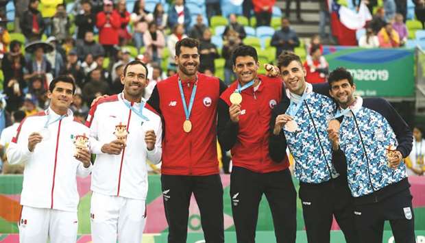 Chileu2019s Marco Grimalt and Esteban Grimalt (centre) celebrate with Mexicou2019s Juan Virgen and Rodolfo Ontiveros (left) and Argentinau2019s Julian Azaad and Nicolas Capogrosso on the menu2019s beach volleyball podium after winning gold, silver and bronze medals respectively at the Pan Am Games in Lima. (Reuters)