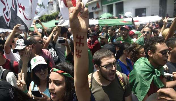 Algerian demonstrators shout slogans as they take part in a protest in Algiers, yesterday.