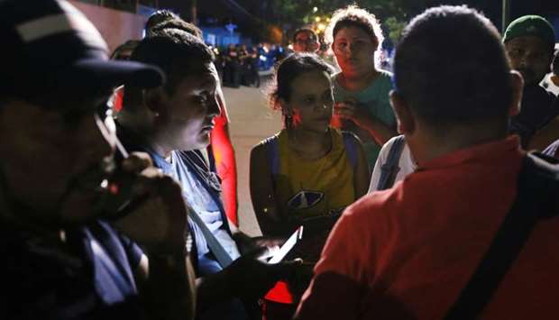 People talk as they wait for news after employees were kidnapped by unidentified individuals from a call center, in Cancun