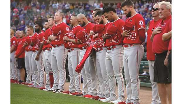 Los Angeles Angels players hold a moment of silence in memory of Tyler Skaggs before their game against the Texas Rangers in Arlington, Texas, on Tuesday. (USA TODAY Sports)