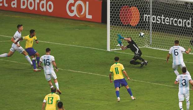 Brazilu2019s Gabriel Jesus (second left) scores past Argentinau2019s goalkeeper Franco Armani during the Copa America semi-final match at the Mineirao Stadium in Belo Horizonte, Brazil, on Tuesday night. (AFP)