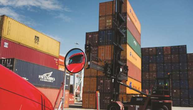 The windshield of a truck reflects in a side mirror as a top loader prepares to move a shipping container at the Port of Savannah in Savannah, Georgia, US (file). US trade deficit with Mexico rose to its highest in a decade, according to a Commerce Department report.