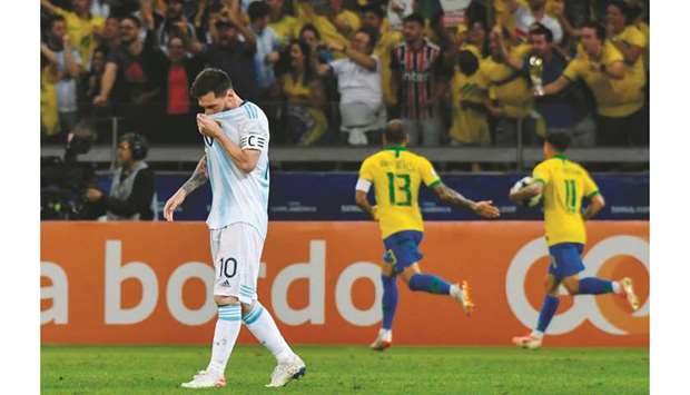 Argentina captain Lionel Messi is dejected as Brazilian players celebrate after Gabriel Jesus scored during the Copa America semi-final in Belo Horizonte, Brazil, on Tuesday night. (AFP)