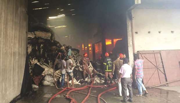 Firefighters and factory workers try to extinguish a fire in a textile factory in Gazipur yesterday.