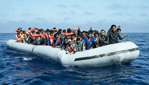 A group of migrants aboard an inflatable boat. File picture