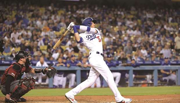 LA Dodgersu2019 Cody Bellinger (right) follows through on a walk-off solo home-run in the tenth inning against the Arizona Diamondbacks on Wednesday. (USA TODAY Sports)