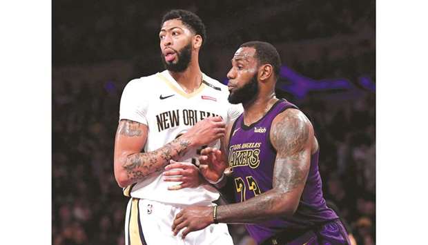 In this December 21, 2019 picture, LeBron James (right) of the LA Lakers guards Anthony Davis of the New Orleans Pelicans during an NBA game in Los Angeles. (TNS)
