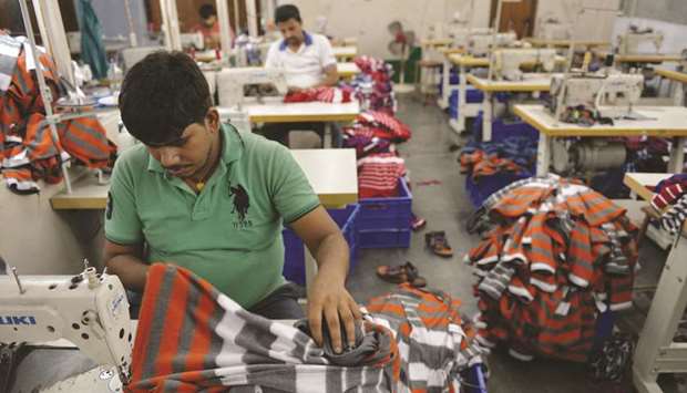 Indian men work at a garment factory in Ludhiana.
