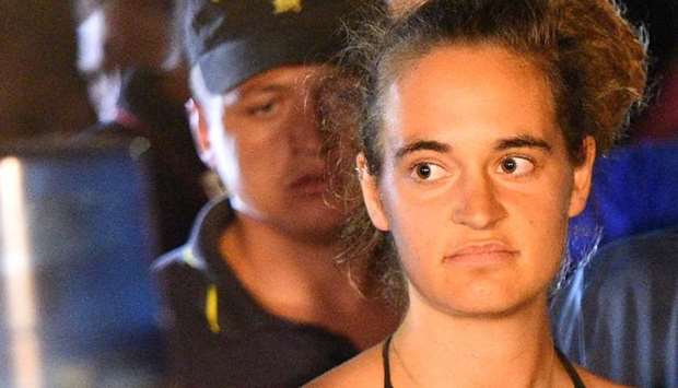 Carola Rackete, 31-year-old Sea-Watch 3 captain, is escorted off the ship by police and taken away for questioning, in Lampedusa, Italy on June 29