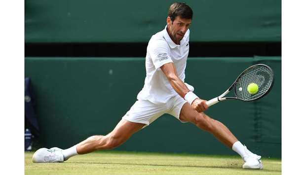 Serbiau2019s Novak Djokovic returns against Polandu2019s Hubert Hurkacz (not pictured) during their Wimbledon third round match at The All England Club in London yesterday. (AFP)