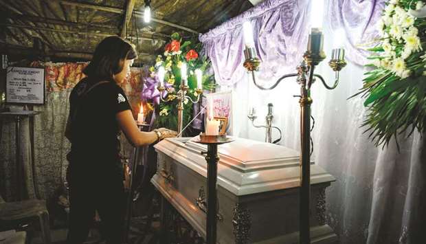 The coffin of three-year-old baby Kateleen Myca Ulpina, killed during a sting operation conducted by the police, is seen during her wake in Rodriguez, Rizal, east of Manila, yesterday.