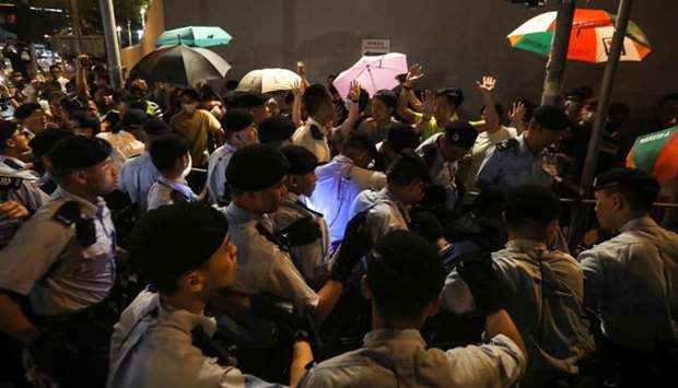 Policemen face protesters during a demonstration in the north-western district of Tuen Mun, near the border with the Chinese city of Shenzhen, in Hong Kong on as tensions continue between police and protesters against a proposed extradition bill