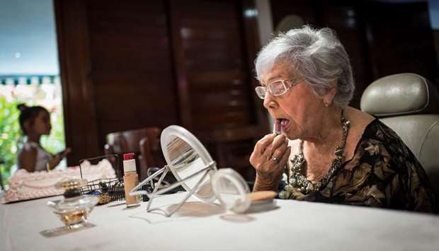 Delia Barroso, 102, puts on make-up for her birthday in Havana on May 18, 2019.
