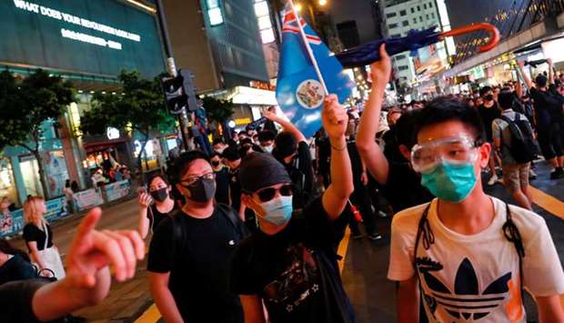 Anti-extradition bill protesters march with the colonial Hong Kong flag at the tourism district Nathan Road near Mongkok, Hong Kong