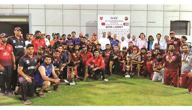 Qatar Cricket Association president Yousef Jeham al-Kuwari and other officials pose with the Qatar and Kuwait teams after the hosts won the Twenty20 International series at the Asian Town Cricket Stadium on Saturday.