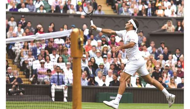 Switzerlandu2019s Roger Federer returns against Italyu2019s Matteo Berrettini (not pictured) during their Wimbledon fourth round match at The All England Club in London yesterday. (AFP)