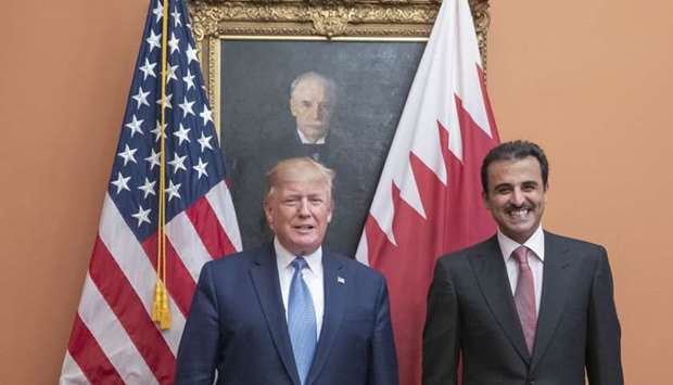 His Highness the Amir Sheikh Tamim bin Hamad al-Thani and US President Donald Trump pose for a photograph 
