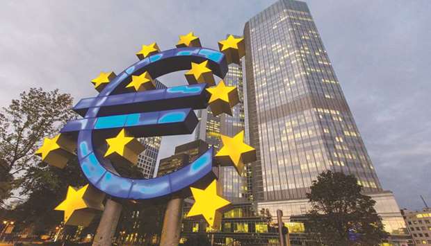 A euro sign sculpture stands illuminated in front of the European Central Bank (ECB) headquarters in Frankfurt, Germany.