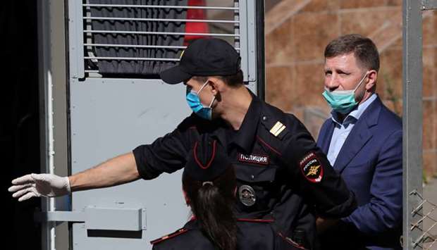 Governor of Khabarovsk Region Sergei Furgal, accused of crimes including attempted murder, is escorted to a police vehicle after a court hearing in Moscow, Russia