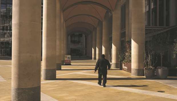 A man walks past the London Stock Exchange building. The FTSE 100 closed up 0.8% to 6,095.41 points yesterday.