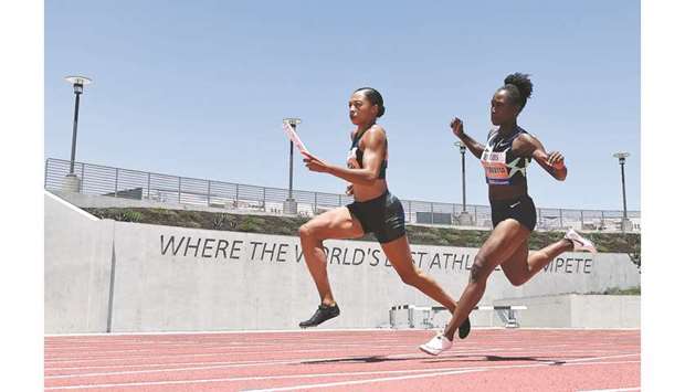 Allyson Felix (left) takes a handoff from Tianna Bartoletta on their way to a first place finish in the womenu2019s 3x100m relay during the Weltklasse Zurich Inspiration Games in Walnut, California, on Thursday. (AFP)