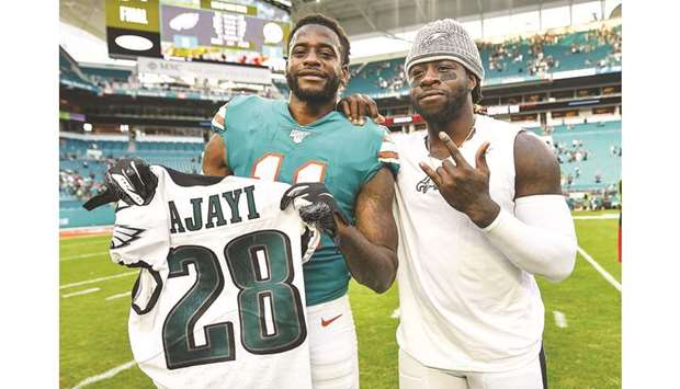 DeVante Parker (left) of the Miami Dolphins and Jay Ajayi of the Philadelphia Eagles swap jerseys after the game at Hard Rock Stadium in Miami on December 1, 2019. (AFP)