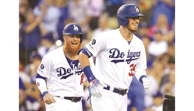 The Los Angeles Dodgersu2019 Cody Bellinger (right) reacts following his three-run home run against the St. Louis Cardinals at Dodger Stadium in Los Angeles on August 5, 2019. (TNS)