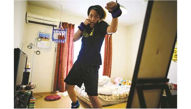 Japanese boxer Arisa Tsubata exercising at her apartment in Saitama on June 18, 2020. (AFP)