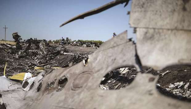 In this 2014 July file photo, a part of the Malaysia Airlines Flight MH17 is seen at the crash site.