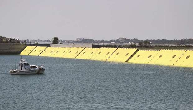 Yellow mobile barriers are seen above the surface of the water during tests of flood barrier project Experimental Electromechanical Module (Mose) in Venice yesterday.