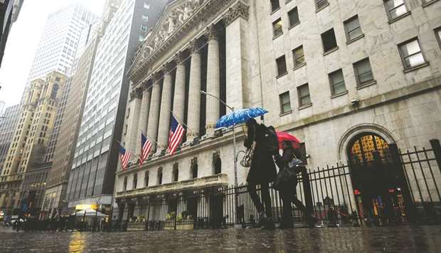 People pass the New York Stock Exchange. Wall Street investors will watch next weeku2019s earnings from BlackRock, the worldu2019s largest asset manager, for a snapshot of how the industry performed during the second quarteru2019s dramatic rebound in global financial markets.