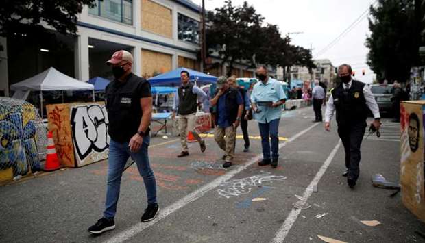 Members of the Seattle Police homicide unit leave the scene of a fatal shooting in the CHOP (Capitol Hill Organized Protest) area as people occupy space in the aftermath of the death in Minneapolis police custody of George Floyd, in Seattle, Washington, US on June 29