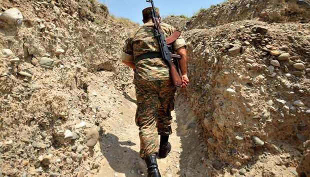 An Armenian soldier of the self-proclaimed republic of Nagorno-Karabagh walks in a trench at the frontline on the border with Azerbaijan near the town of Martakert. File picture: July 11, 2012