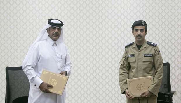 Director of the Police Training Institute Major Ali Saud al-Hanzab, and the Director of the Customs Training Centre, Mubarak Ibrahim al-Buainain after signing the MoU.