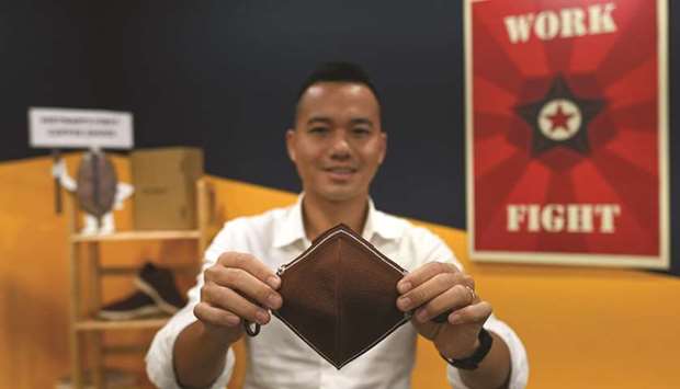 Le Thanh posing with a facemask made from coffee grounds at his co-working space in Ho Chi Minh City.