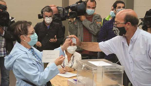 A woman wearing a protective face mask votes during the Basque regional elections in Durango yesterday.