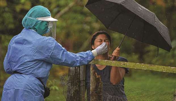A health worker collects a nasal swab sample of a resident to test for Covid-19 in Arraijan district, 23km west of Panama City. Panama is the country with the highest rate of Covid-19 cases in Central America and the Caribbean.