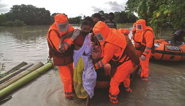 National Disaster Response Force (NDRF) personnel carry a sick woman during a rescue operation in a flood-affected area in Pathsala of Barpeta district, some 105km from Guwahati, in Assam yesterday.