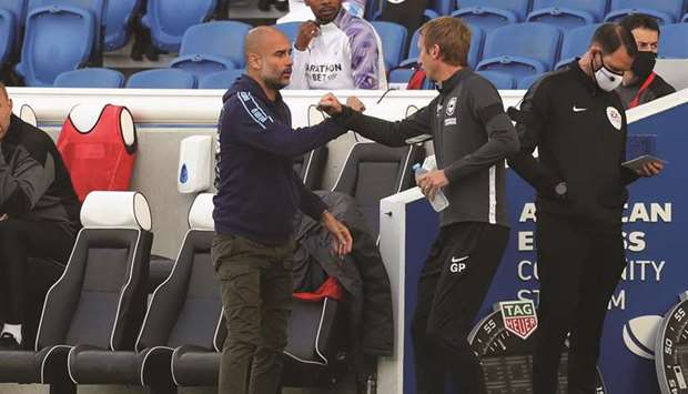 Brighton & Hove Albion manager Graham Potter and Manchester City manager Pep Guardiola greet each other before their teamu2019s Premier League match on Saturday.